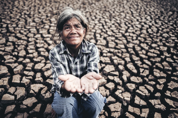 Free photo elderly women make hands to get rainwater in dry weather, global warming, selected focus.