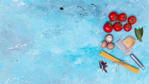 Free Photo elevated view of fresh vegetarian ingredient for making spaghetti pasta 