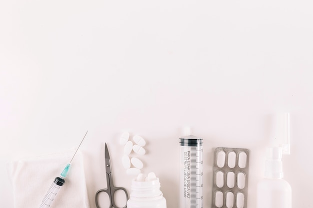 Free Photo elevated view of pills and medical equipments on white background