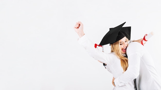 Embracing couple celebrating graduation