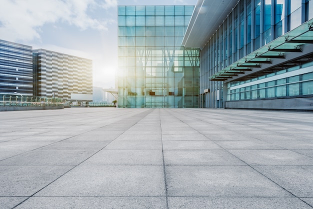 Free photo empty brick floor with modern building in background