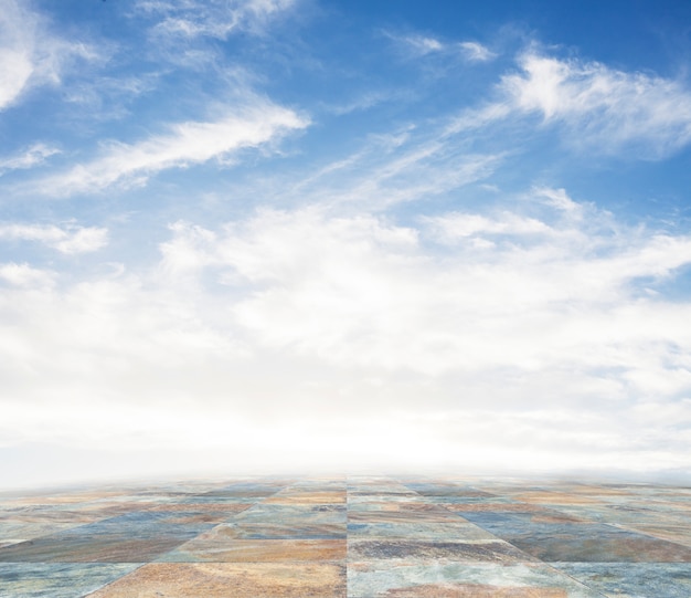 Free photo an empty scene of a stone tile floor and a blue sky