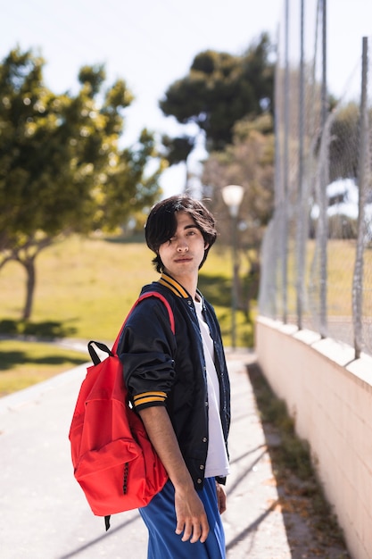 Free photo ethnic pupil after school in park