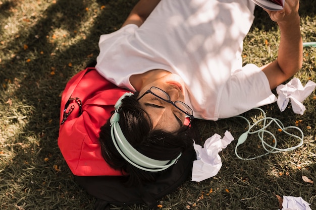 Free Photo ethnic teen laying on ground