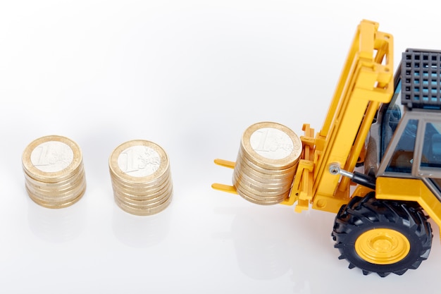 Euro money coins and forklift on white space