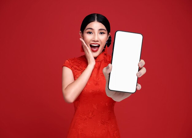 Excited Beautiful chinese Asian woman holding smartphone mockup of blank screen