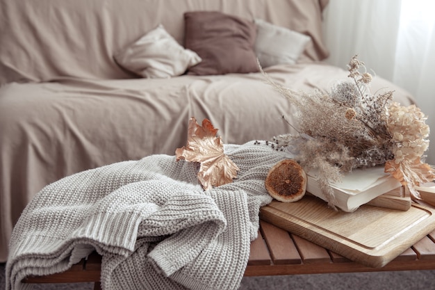 Free photo fall vibe with fall decor details and a knitted sweater in the room.