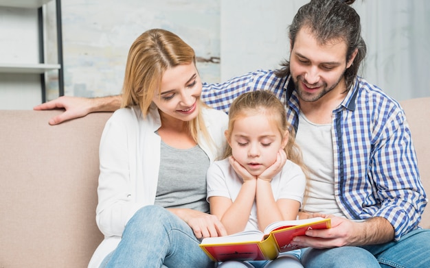 Free photo family reading on the sofa