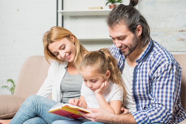 Free photo family reading on the sofa