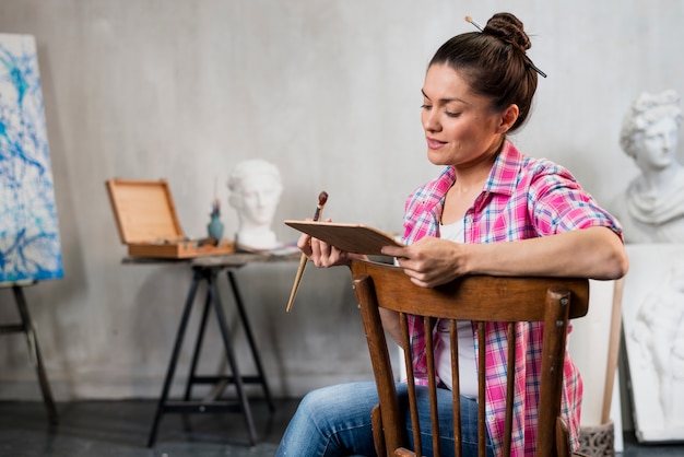 Free Photo female artist on chair