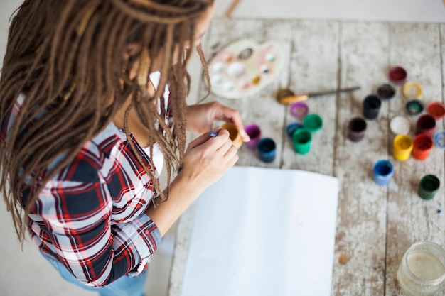 Female artist painting indoors