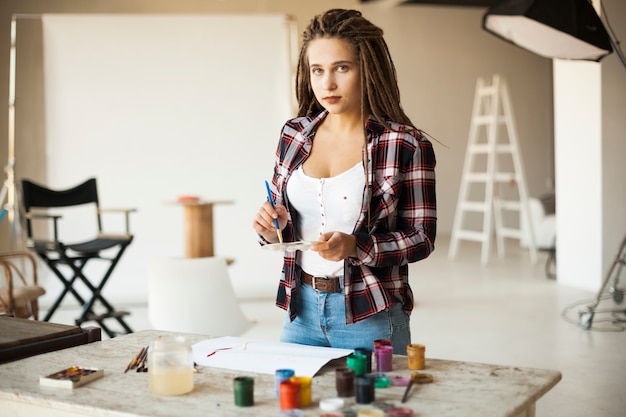 Female artist painting indoors