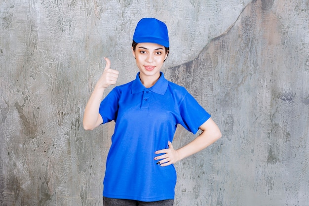 Free photo female service agent in blue uniform showing positive hand sign