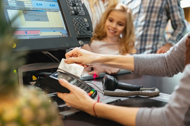 Free Photo female staff using credit card terminal at cash counter