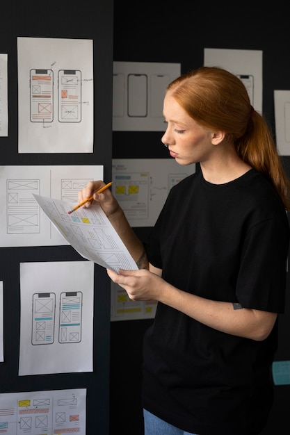 Free photo female web designer taking notes in the office