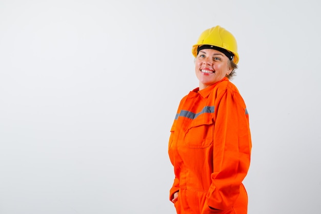 Free photo firewoman in her uniform with a safety helmet