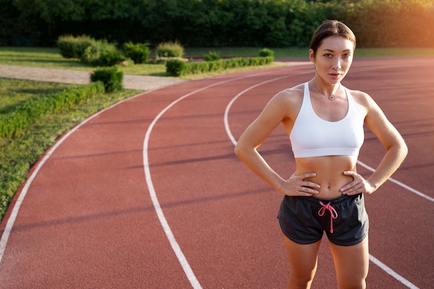 Free photo fit woman on running track front view