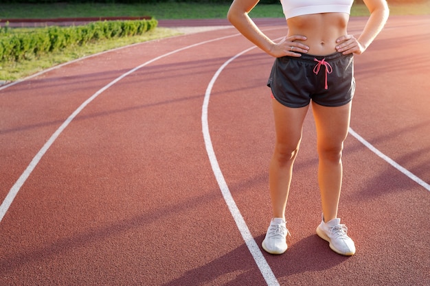 Free photo fit woman on running track side view