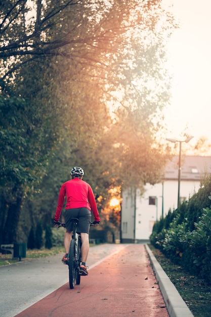 Free photo fitness boy with bike on the road