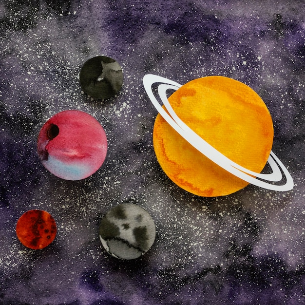 Free photo flat lay assortment of creative paper planets