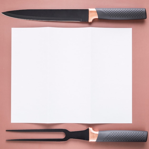 Free photo flat lay of blank menu paper with knife and fork