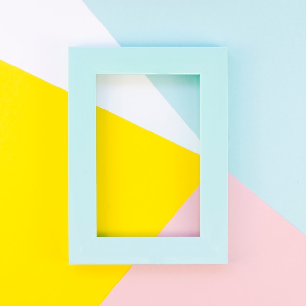 Free photo flat lay of colorful frame on paper shapes