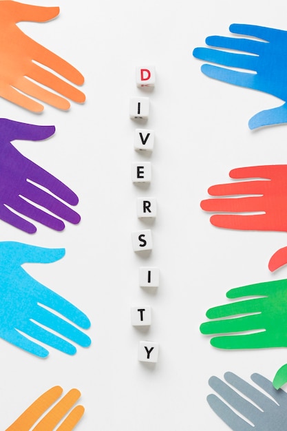 Free photo flat lay diversity assortment with different colored paper hands