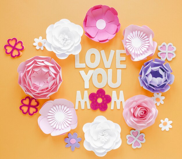 Flat lay paper flowers on orange background