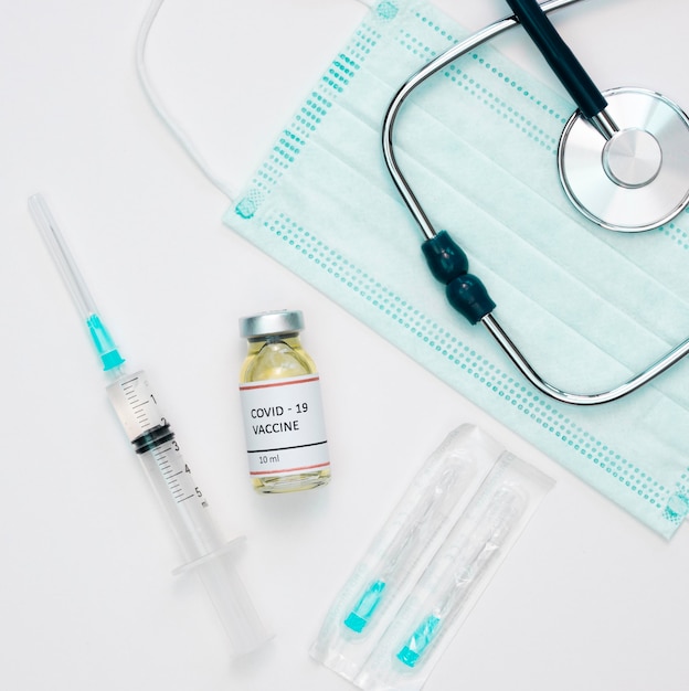 Free Photo flat lay of vaccine with syringe and stethoscope