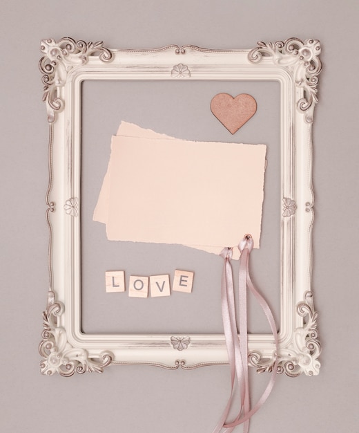 Free Photo flat lay wedding invitation mock-up in vintage frame