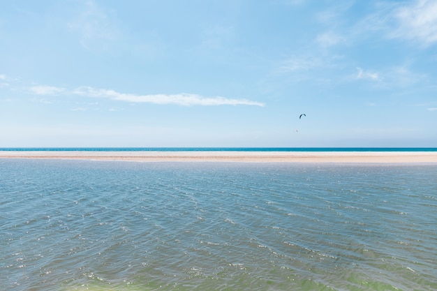 Free Photo flying with parachute on exotic seashore