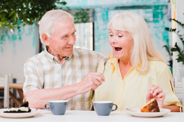 Free Photo fooling loving  elderly gray haired couple 