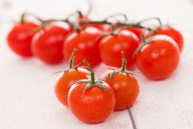 Free Photo fresh cherry tomatoes on a white surface 