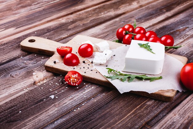 Free photo fresh and healthy food. delicious italian dinner. fresh cheese served on wooden board