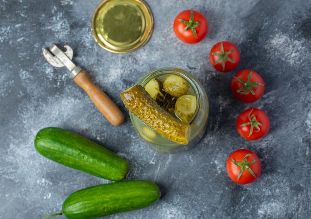 Free Photo fresh and pickled vegetables. opened pickle jar with fresh tomato and cucumber