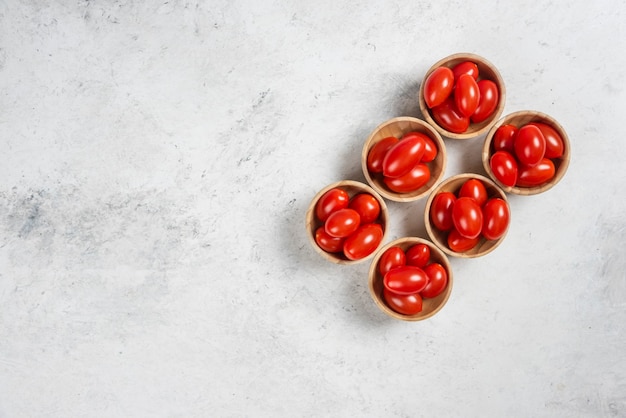 Free Photo fresh red cherry tomatoes in wooden bowls.