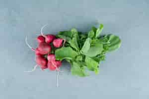 Free photo fresh red turnips on marble.