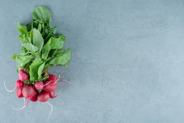 Free photo fresh red turnips on marble.