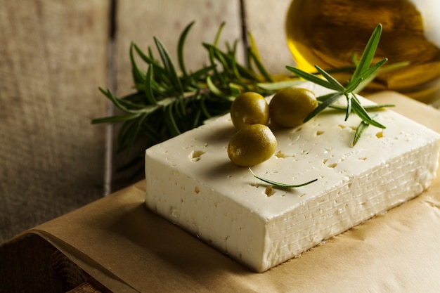 Free photo fresh tasty greek green olives with cheese feta or goat cheese. closeup. mediterranean food.