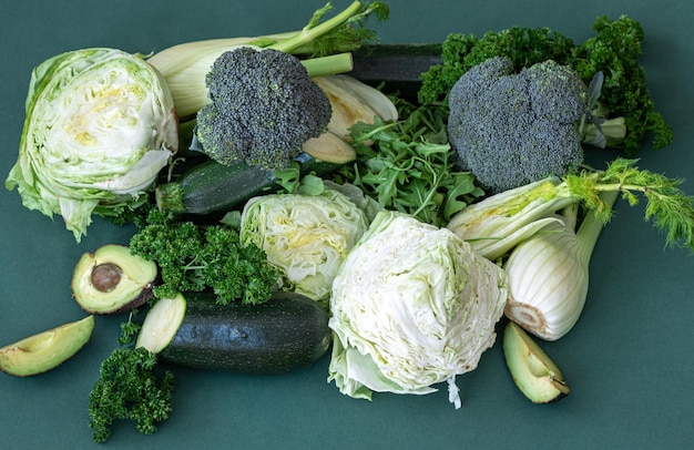 Free photo fresh vegetables and greens on a green background