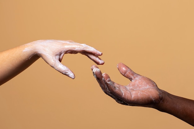 Friends washing hands with soap