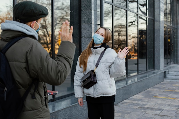 Free Photo friends with mask waving