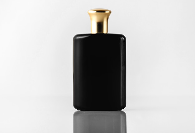 Free photo a front view black fragrance designed with gold cap on the white floor