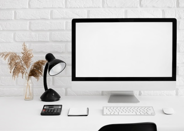 Free Photo front view of desk with computer and lamp