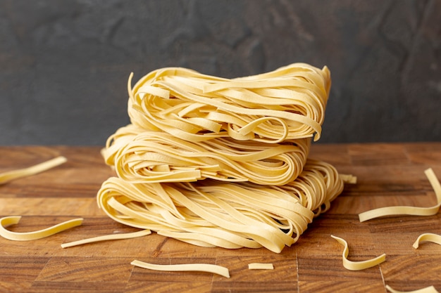 Free photo front view of italian pasta on wooden table