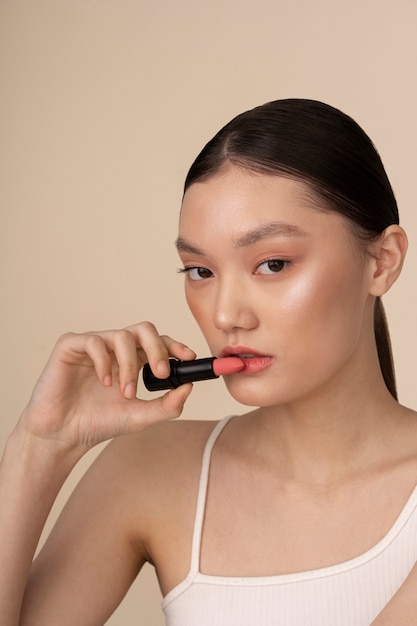 Free Photo front view korean woman posing with lipstick