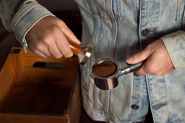 Free photo front view man making coffee