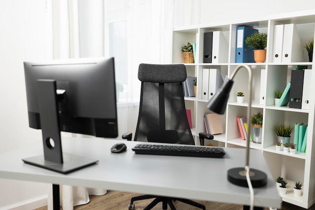 Free Photo front view of office desk with computer and chair