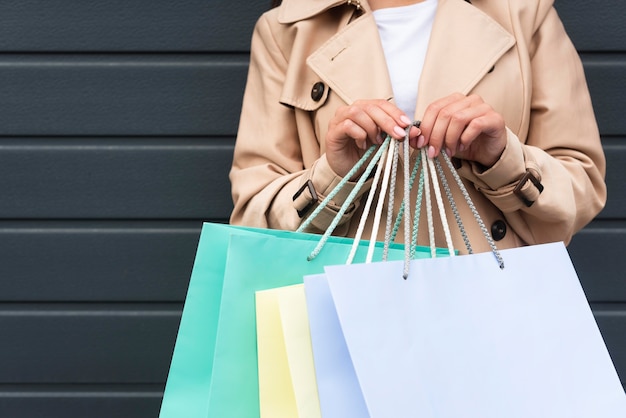 Free photo front view of woman holding lots of shopping bags