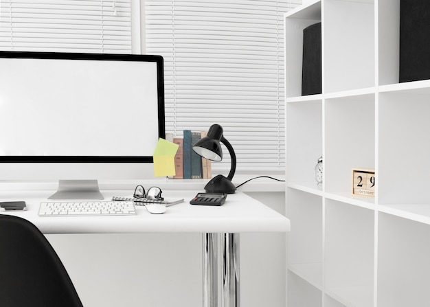 Free photo front view of workspace with computer screen and lamp